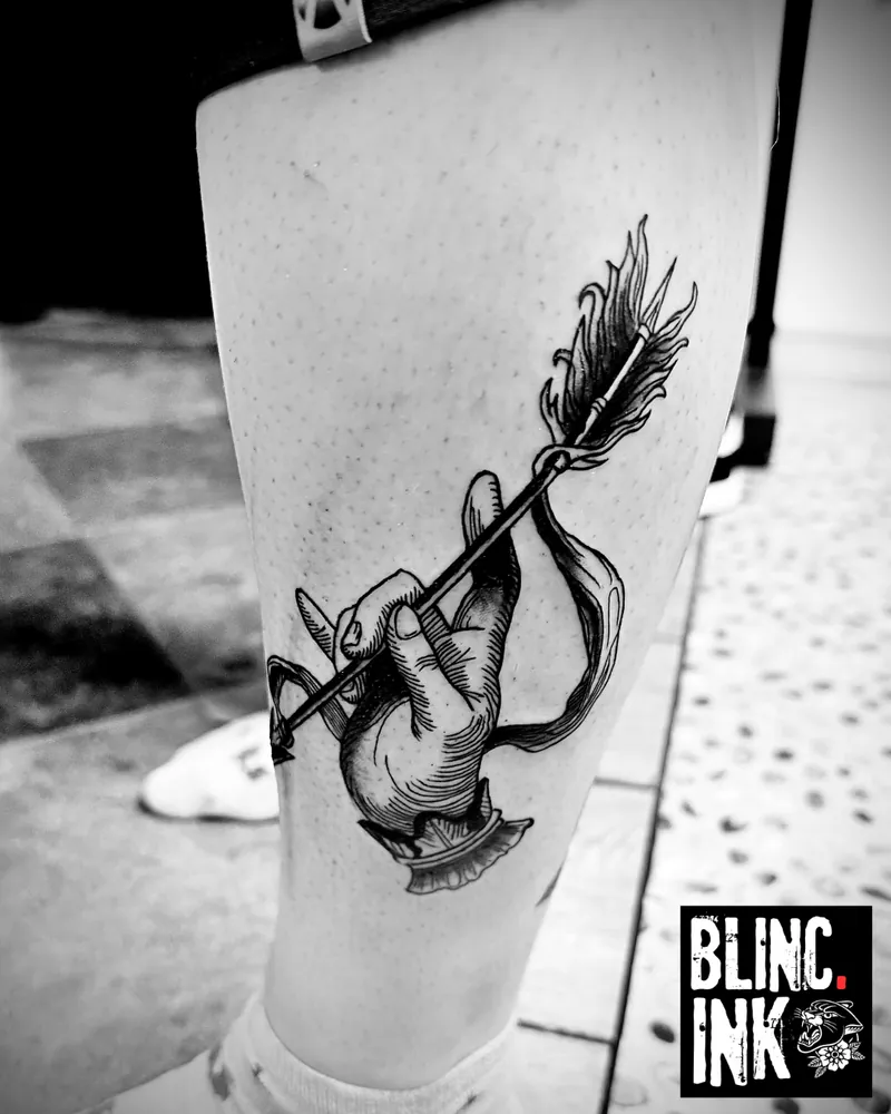Hand & Arrow: a custom engraving-style tattoo on the lower leg by Clive Camilleri at Dermoda Studio, Highbridge, Somerset.
